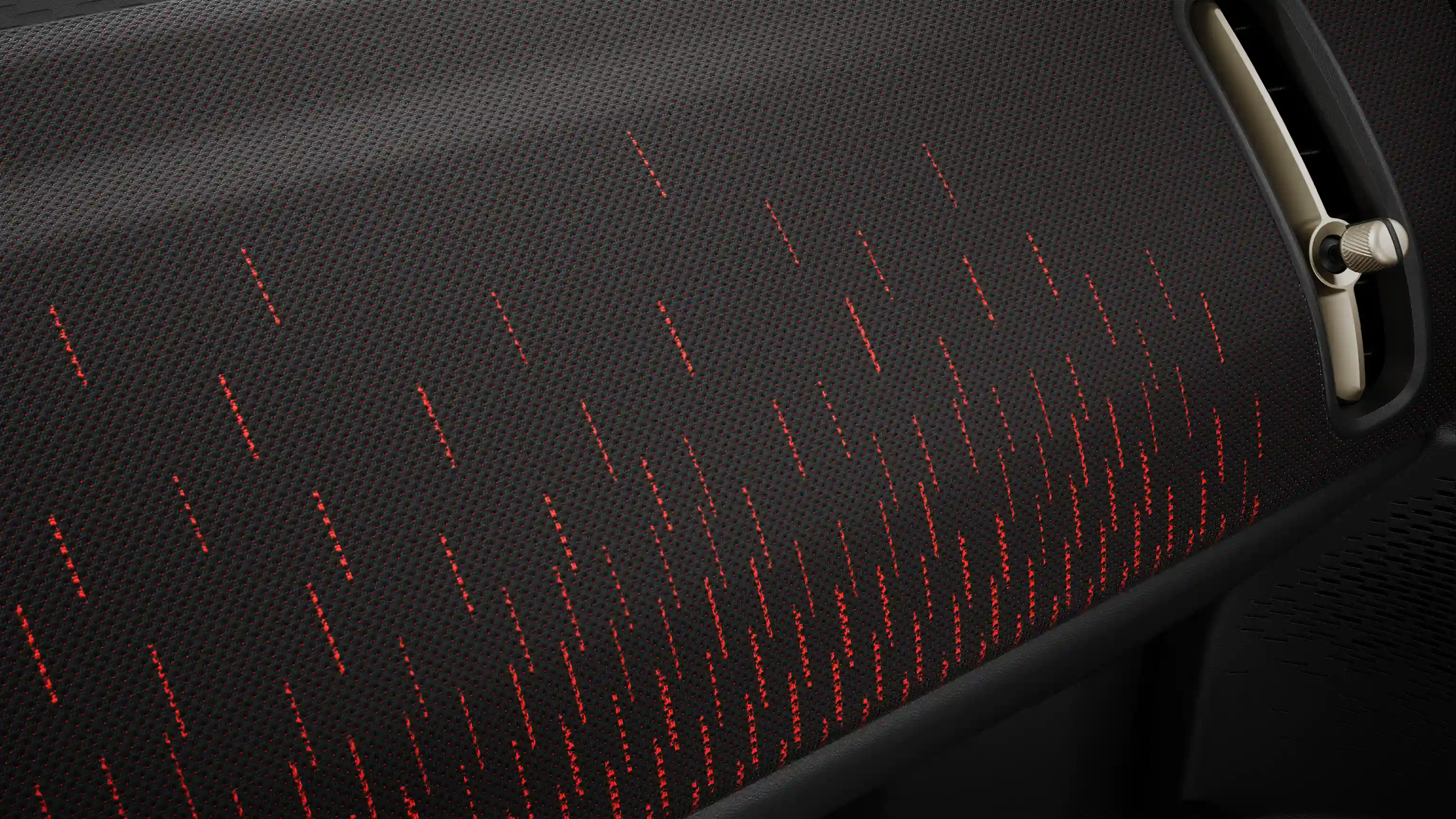 Pohled na palubní desku v červené a černé barvě elektrického MINI Countryman s paketem JCW