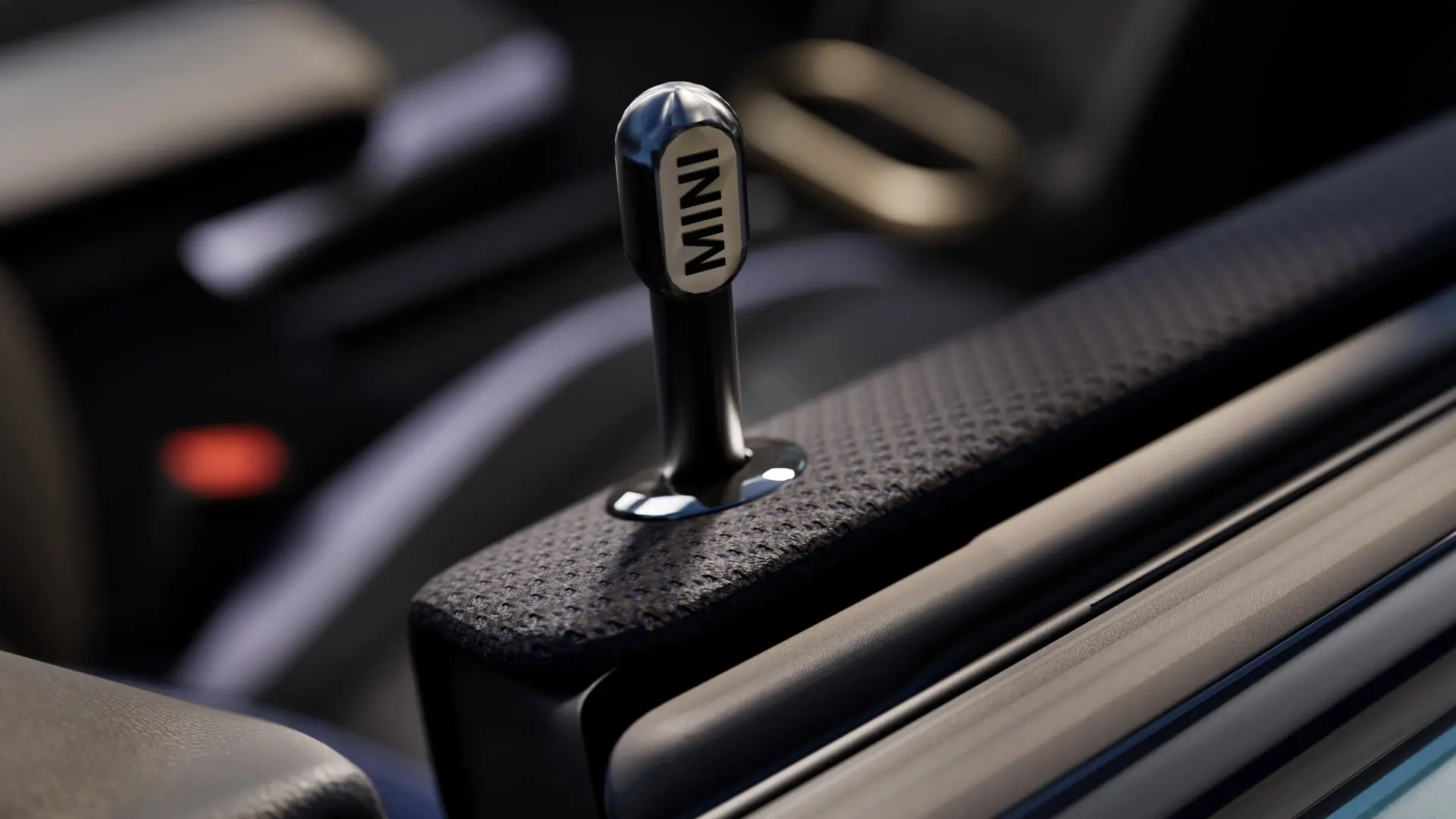 Detailní pohled na originální MINI Dveřní zamykací kolíček z černého eloxovaného hliníku.