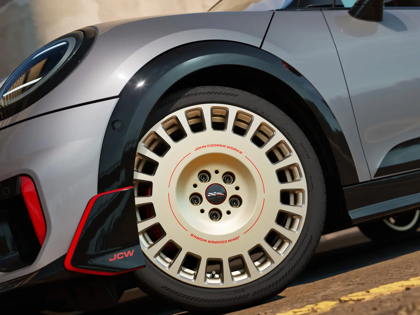 Detailní pohled na 18" JCW kolo Rallye Spoke 964 ve stříbrné barvě Bicolour Vibrant Silver frézované diamantem a přední winglet.