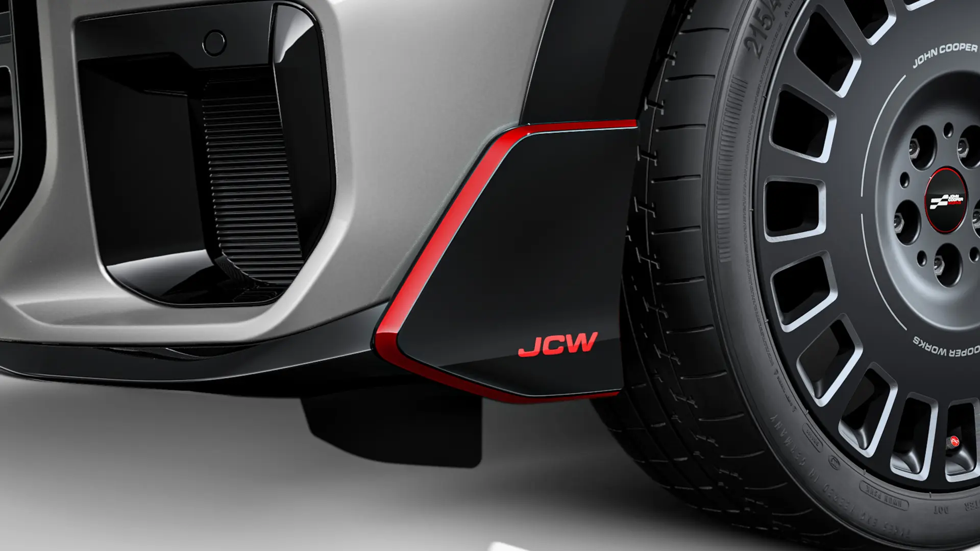 MINI John Cooper Works přední wingler v leskle černém provedení s červeným nápisem JCW a ozdobnými proužky